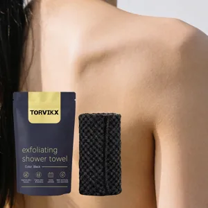 Black mesh exfoliating shower towel with premium TORVIKX retail packaging close up detail