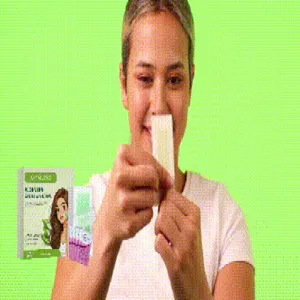 Detailed view of a person using a JAYSUING hair removal wax strip for smooth skin results