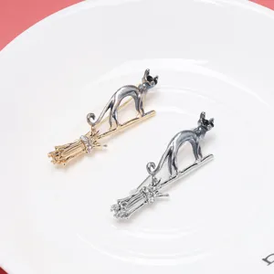 Creative flying broom cat brooch pins in gold and silver finish with rhinestone details