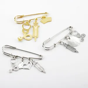 Detailed view of creative medical brooches featuring syringe and stethoscope charms