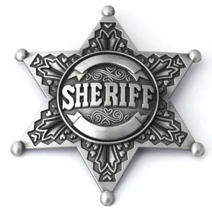 Detailed macro shot of an antique silver six-pointed sheriff star badge with relief text