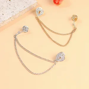 Detailed view of gold and silver heart key chain brooches with sparkling crystals