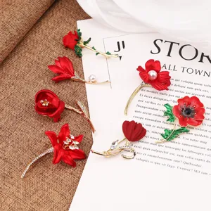 Elegant collection of red floral brooches with pearls and sparkling rhinestones.