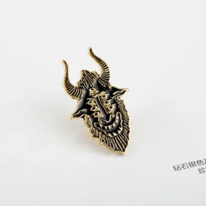 Detailed macro shot of an enamel goat devil pin with gold and black finish