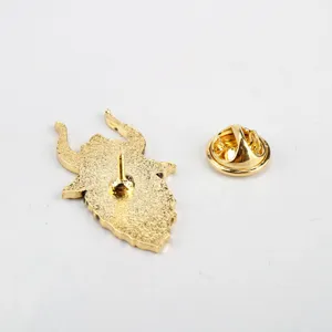 Detailed back view of golden Halloween demon claw enamel pin showing needle and clutch