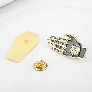 Detail view of Doom skeletal claw enamel pin with coffin-shaped gold back and clutch