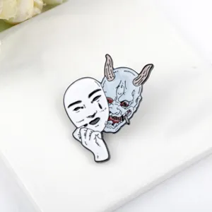 Detailed view of a Hannya demon and face mask enamel pin for Halloween.