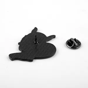 Detailed back view of a black metal cartoon Hannya mask brooch with pin and clutch