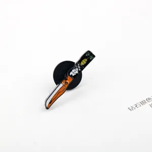 Detail view of the cartoon dagger enamel pin inspired by the Chucky horror movie.