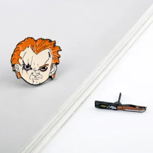 Detailed macro shot of Chucky movie character enamel pin set featuring a cartoon dagger