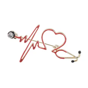 Detailed view of the red heart-shaped stethoscope brooch with crystal accent