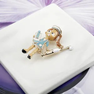 Detailed close-up of a cute cartoon nurse enamel brooch with a golden syringe accent