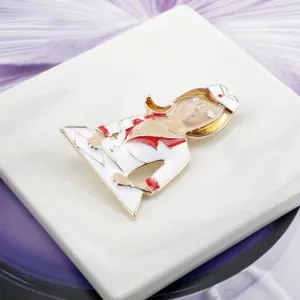 Close-up detail showing the enamel craft of a cartoon nurse brooch pin with gold plating