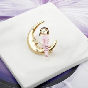 Close-up of a cartoon girl sitting on a golden crescent moon brooch with stones