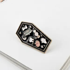 Detailed view of Halloween coffin enamel pin with ghost, bat, and pumpkin motifs