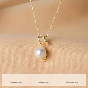 Macro detail of natural round freshwater pearl pendant on S925 sterling silver chain