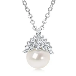 Macro view of a round white freshwater pearl pendant with sparkling stone cluster