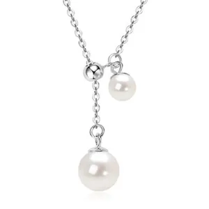 Close-up detail of round freshwater pearl pendant necklace on a sterling silver chain