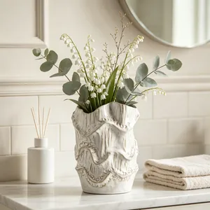 Detailed view of the wavy textured ceramic vase with elegant floral arrangement