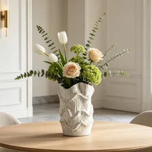 Macro view of artistic ceramic vase with wavy texture and elegant floral arrangement