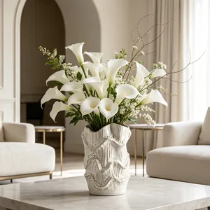 Artistic retro ceramic flower vase with white Calla lilies in a modern home setting