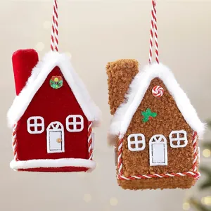 Close-up of plush red and brown house Christmas ornaments with hanging strings