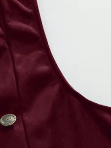 Close-up of burgundy velvet suit vest showing fine fabric texture and ornate button