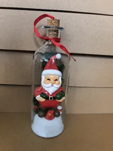 Detailed view of Christmas message bottle with Santa figurine inside