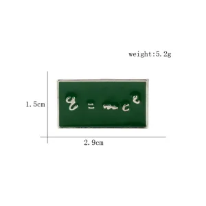 Green enamel brooch featuring E=mc2 formula with size and weight markings