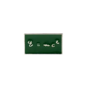 Close-up detail of a green enamel pin featuring the E=mc² physics equation design