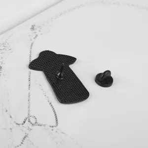 Back view of black alien UFO enamel pin with textured metal finish and rubber clutch