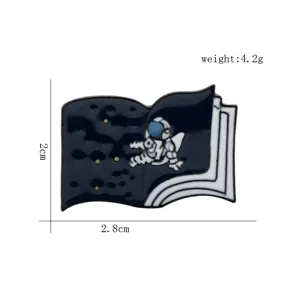 Detailed view of astronaut and space book enamel pin with 2.8cm size and 4.2g weight