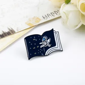 Detailed view of a cartoon astronaut enamel pin featuring a starry night book design