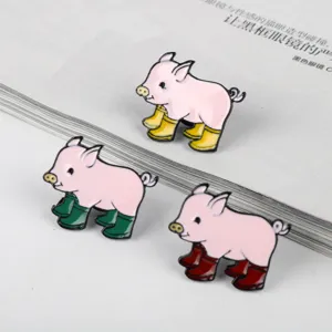 Detail of cute pink pig enamel pins wearing colorful boots for bag and collar decoration