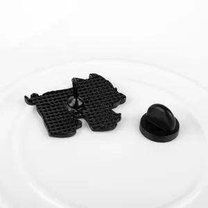 Close-up rear view of black enamel pig pin showing textured back and rubber clutch