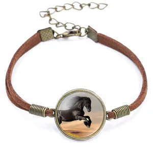 Detail of a 20mm bronze bracelet with a black horse cabochon and brown velvet cord.
