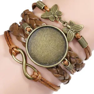Detail of hand-woven bracelet with bronze butterfly and infinity charms on a wrist