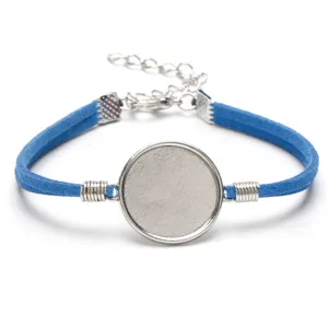 Close-up detail of 20mm silver round bezel setting with blue suede cord bracelet