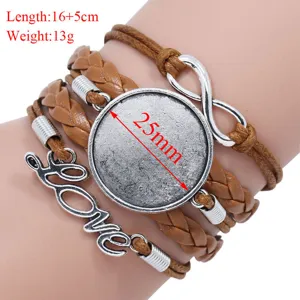 Macro view of handmade braided multilayer bracelet with 25mm round base and charms