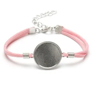 Macro view of a 20mm round alloy bezel tray on a pink Korea velvet cord bracelet.