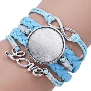 Close-up detail of blue braided multilayer bracelet with Love and infinity charms