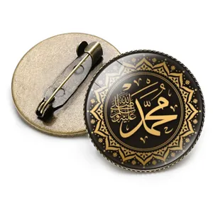 Detailed view of Islamic calligraphy brooch with bronze metal back and glass dome