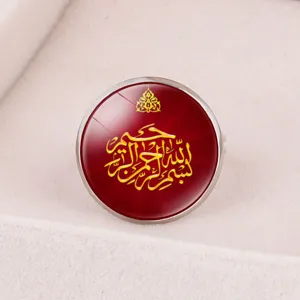 Macro view of a Middle Eastern style ring with red dome and gold Arabic calligraphy