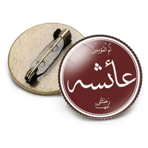 Detailed close-up view of bronze round brooch featuring Arabic calligraphy design
