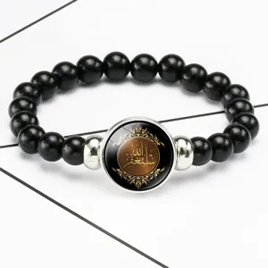 Close-up of black beaded stretch bracelet with Arabic calligraphy glass cabochon