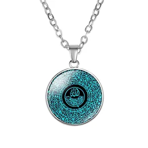 Detail shot of a silver necklace with an Arabic calligraphy glass cabochon pendant