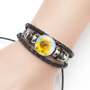 Detailed macro view of a black multi-layer cowhide bracelet with sunflower glass charm