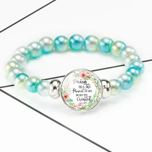 Close-up of pearl stretch bracelet with Bible quote Esther 4:14 in floral time gem pendant