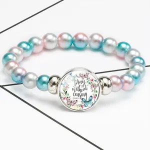 Detail view of colorful beaded bracelet featuring an inspirational quote gem