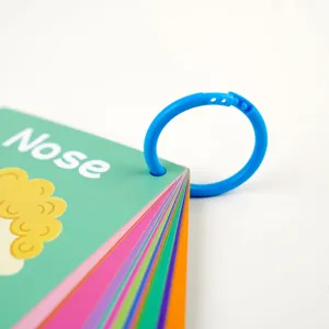Close-up detail of colorful early learning flashcards with a blue plastic binding ring